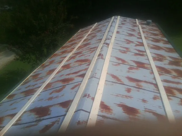 Rusted metal roof panels with new wood purlins before replacement — Storm Damage Roof Repair in Mcclellan by Roofing Brothers